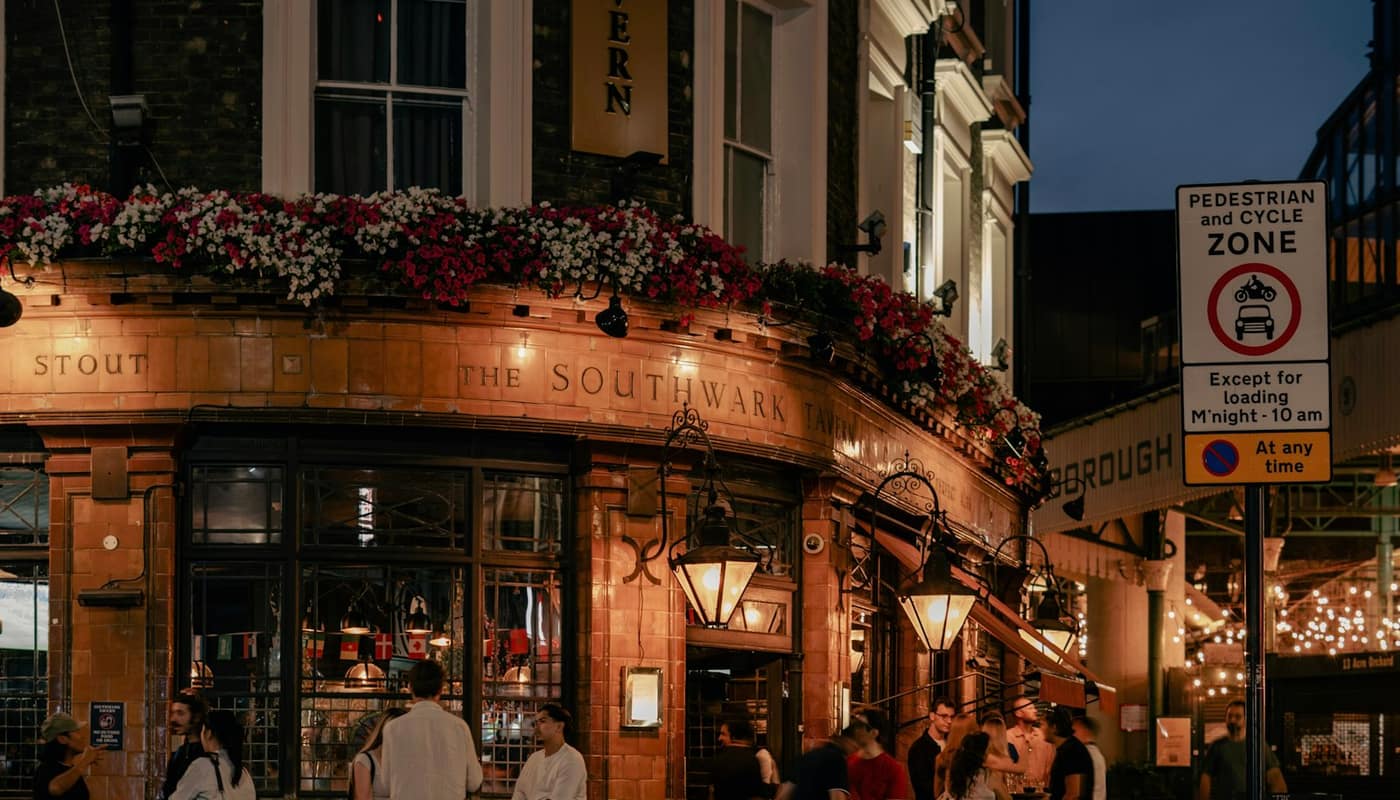 People gathered outside a lively pub at dusk